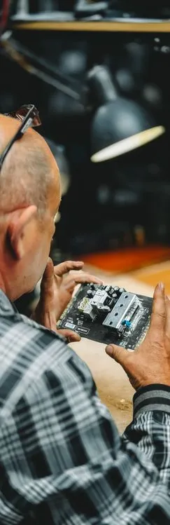 Electrical contractor inspecting circuit board during free estimate assessment