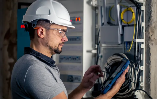 Property manager inspecting LED lighting installation across a multi-tenant commercial building facility